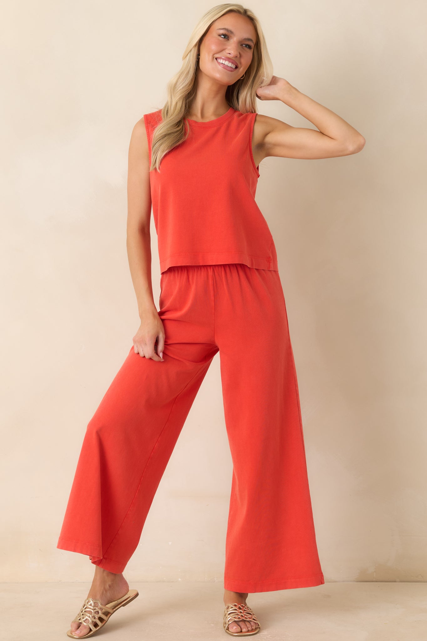Sleeveless poppy red jersey tank with a relaxed fit, breathable lightweight fabric, and clean crew neckline design.