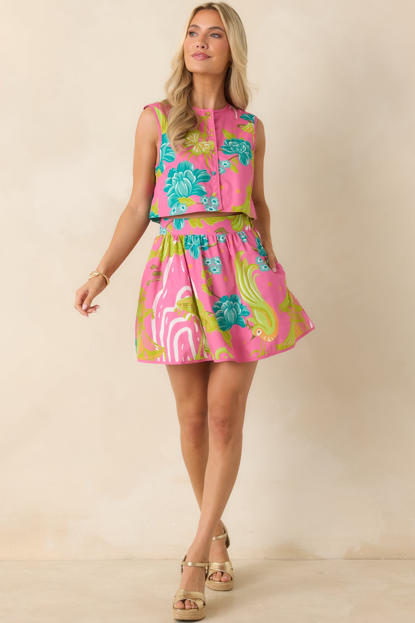 Cotton sleeveless top featuring a clean rounded neckline and bright floral tropical motif throughout.