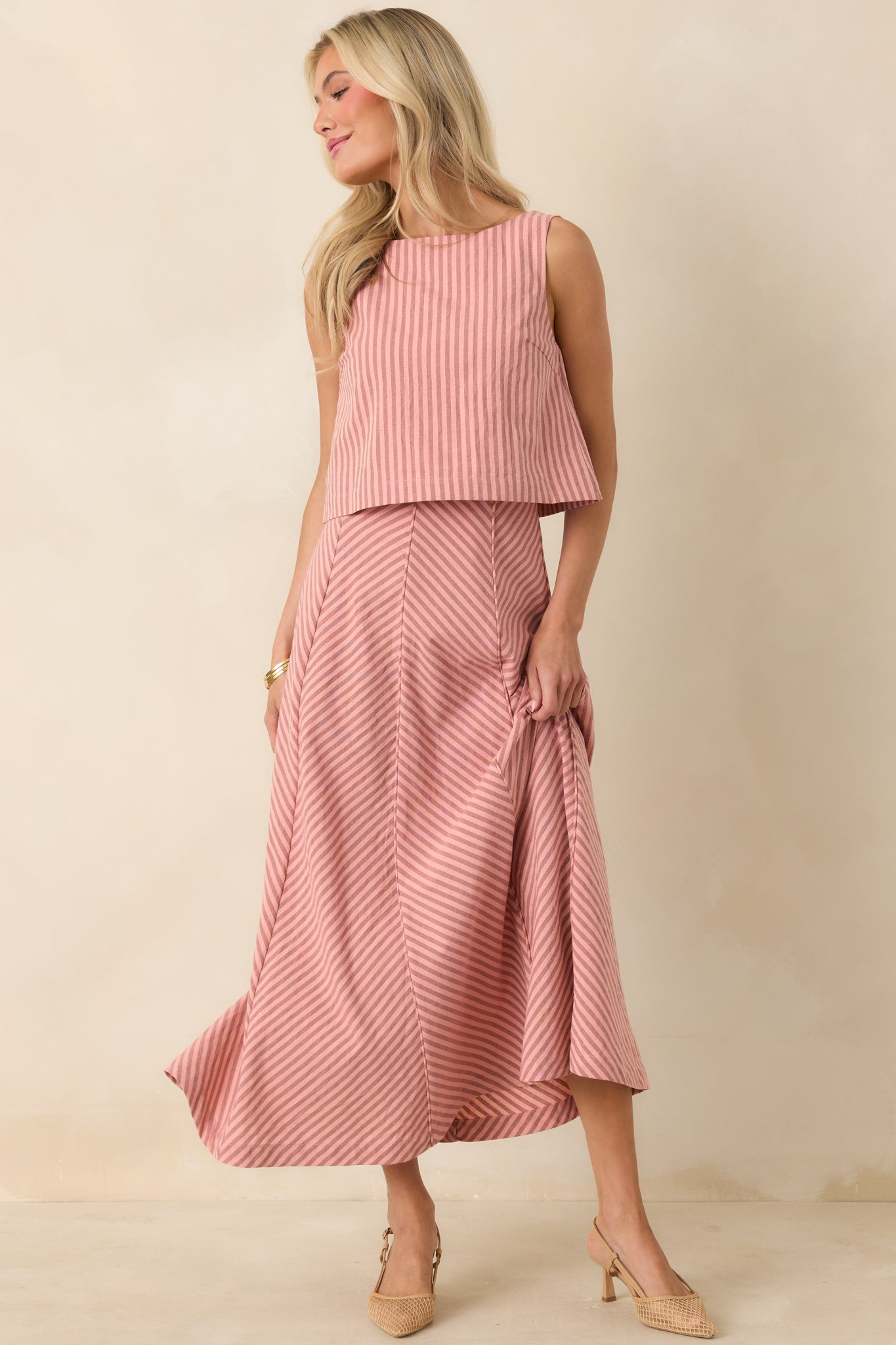 Coral pink striped midi skirt featuring a flattering high waist and subtle paneling for added movement.
