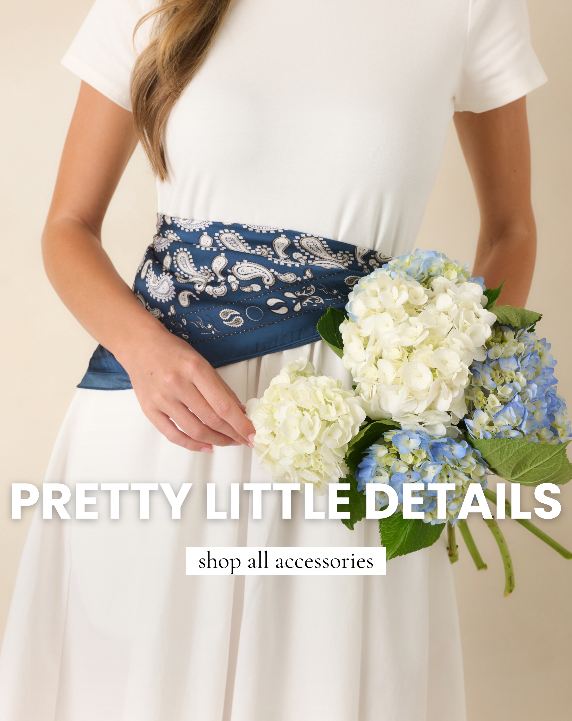 Blue scarf, tied around the waist of a white dress.
