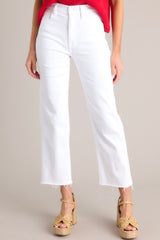 These white jeans feature a high waisted design, classic button & zipper closure, belt loops, functional front & back pockets, a cropped length, and a raw hemline.