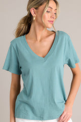Front view of this v-neck green top that features short sleeves and a lightweight fabric.