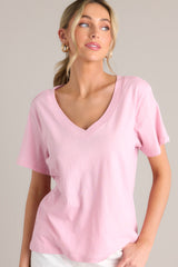 Close up front view of this blush pink top with a graceful v-neckline, short sleeves, and crafted from a breathable lightweight fabric.