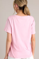 Back view of this blush pink top with a graceful v-neckline, short sleeves, and crafted from a breathable lightweight fabric.