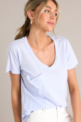 Vibrant iris tee with a v-neckline, practical chest pocket, ultra-soft fabric, and a gracefully scooped hemline.