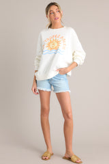 Full body view of that features a crew neckline, a summer themed graphic, ribbed cuffed long sleeves, and a ribbed hemline.