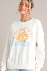 Front view of that features a crew neckline, a summer themed graphic, ribbed cuffed long sleeves, and a ribbed hemline.