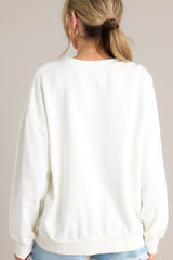 Back view of that features a crew neckline, a summer themed graphic, ribbed cuffed long sleeves, and a ribbed hemline.