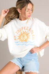 This sweatshirt features a crew neckline, a summer themed graphic, ribbed cuffed long sleeves, and a ribbed hemline.