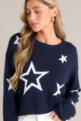 Close up view of this top that features a crew neckline, a slightly cropped style, a fun star print, and a relaxed fit.