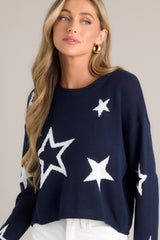 Close up angle view of this top that features a crew neckline, a slightly cropped style, a fun star print, and a relaxed fit.