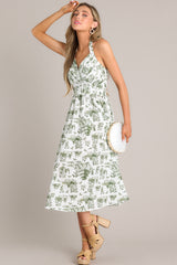 This white and green dress features a self-tie halter neckline, a fully smocked back, a pleated chest, a thick waistband, and a lightweight material.