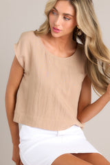 Front view of this top that features a cap sleeve design, a crew neckline and slightly cropped length.