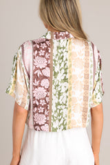 Back view of this shirt that features a collared neckline, functional buttons down the front, and an abstract pattern.