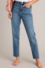 These jeans feature a high waisted design, classic button and zipper closure, functional belt loops, and pockets.