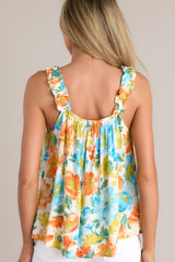 Back view of this top view of this top with a square neckline, ruffled elastic straps, gathering in bust, loose fit, floral pattern.