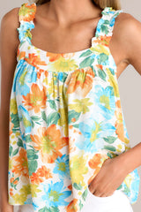 Close up view of this top with a square neckline, ruffled elastic straps, gathering in bust, loose fit, floral pattern.