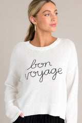 Front view of this white sweater that features a ribbed crew neckline, embroidered wording, a soft knitted fabric, and a ribbed hemline.