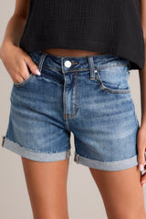 These cuffed denim shorts feature a high waisted design, classic button & zipper closure, belt loops, functional front & back pockets, and a distressed cuffed hemline.