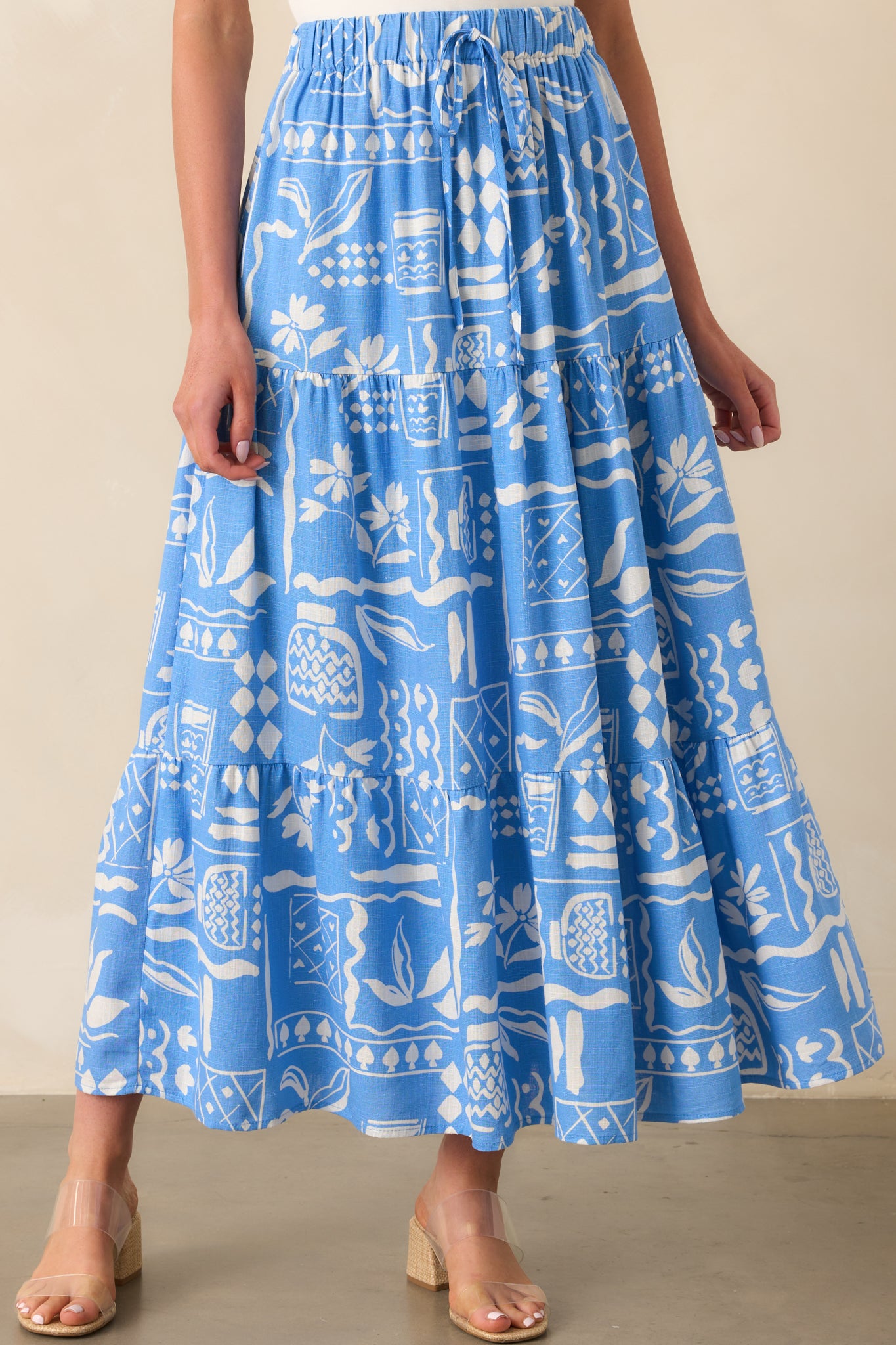 Lower half cropped image capturing the layered structure and movement of the tiered skirt design.