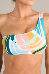 Close up view of this bikini top that features a one shoulder strap and removable pads.