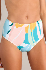 Close up view of these multi-colored bottoms feature a high rise, moderate coverage, and a fun printed design. 