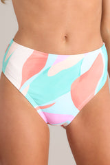 These multi-colored bikini bottoms feature a high waisted design, an elastic waistband, a high cut, and a slightly cheeky backside. 