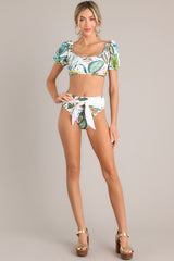 These ivory multi bottoms feature a front self tie, a high rise design, a cheeky back, and a tropical pattern. 