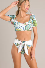 Front view of these bottoms that feature a front self tie, a high rise design, a cheeky back, and a tropical pattern. 