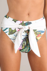 Close up view of these bottoms that feature a front self tie, a high rise design, a cheeky back, and a tropical pattern. 
