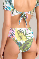 Back view of these bottoms that feature a front self tie, a high rise design, a cheeky back, and a tropical pattern. 