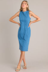 This medium wash dress features a high crew neckline, a keyhole cutout at the back of the neck, a seam down the middle, and a slit in the back hemline.