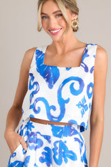 Front view of this top that features a square neckline, thick straps, a discrete side zipper, a unique pattern, and a cropped hemline.