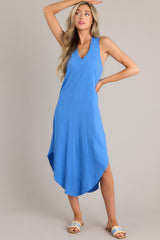Full body view of this blue midi dress that features a v-neckline, a seam down the front and back, a soft & lightweight material, and a scoop hemline.