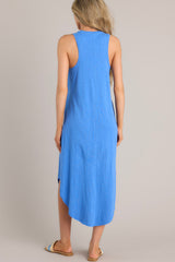 Back view of this blue midi dress that features a v-neckline, a seam down the front and back, a soft & lightweight material, and a scoop hemline.