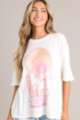 Close up front view of this tee with crew neckline, summer-themed graphic, oversized fit, wide half sleeves.