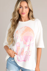 Front view of this tee This tee boasts a classic crew neckline, adorned with a summer-themed graphic, and designed with an oversized fit for ultimate comfort. It features wide half sleeves for a relaxed and breezy look.