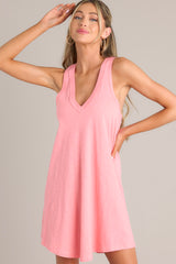 Angled front view of this coral mini dress with v-neckline, flowing silhouette, racerback, ideal for summer.