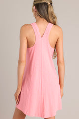 Back view of this coral mini dress with v-neckline, flowing silhouette, racerback, ideal for summer.