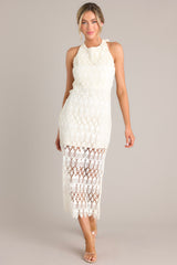 Full front view of this ivory lace dress that features a halter top, and a gorgeous lace overlay. 