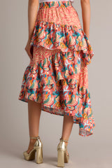 Back view of  this skirt that features an elastic waistband, tiered ruffles, colorful prints, and an asymmetrical hem.