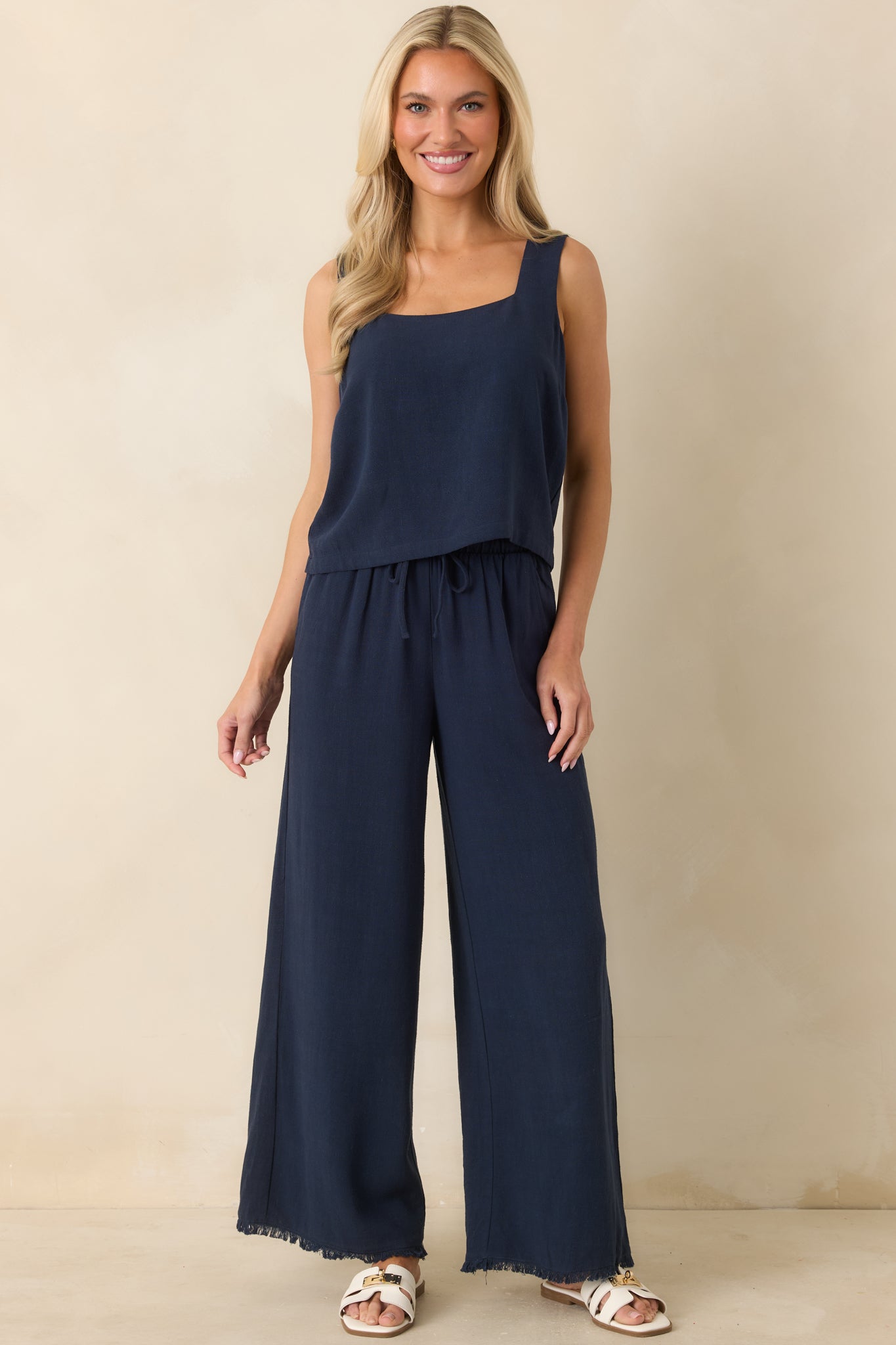 Wide-leg pants featuring a lightweight breathable fabric, elastic drawstring waistband, and relaxed everyday silhouette.
