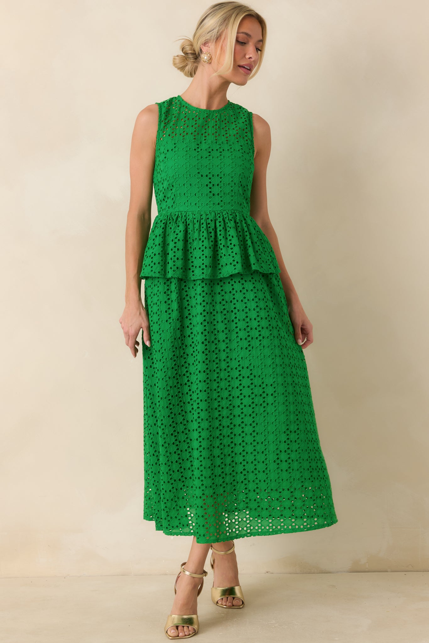 Green sleeveless midi dress showcasing a round neckline, structured eyelet design, and relaxed flowing movement.