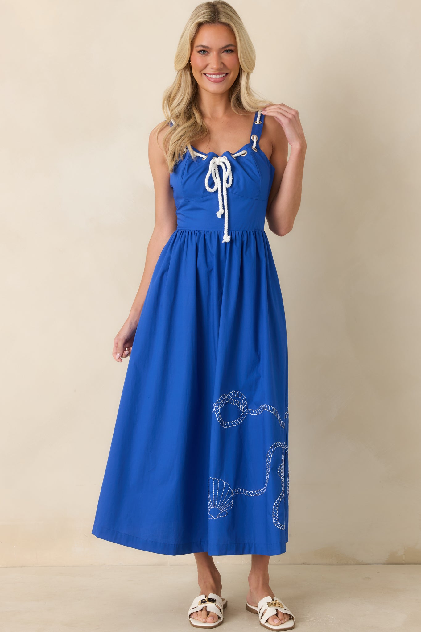 Lightweight royal blue dress with shell-inspired embroidery, a lined body, and an airy midi-length design.