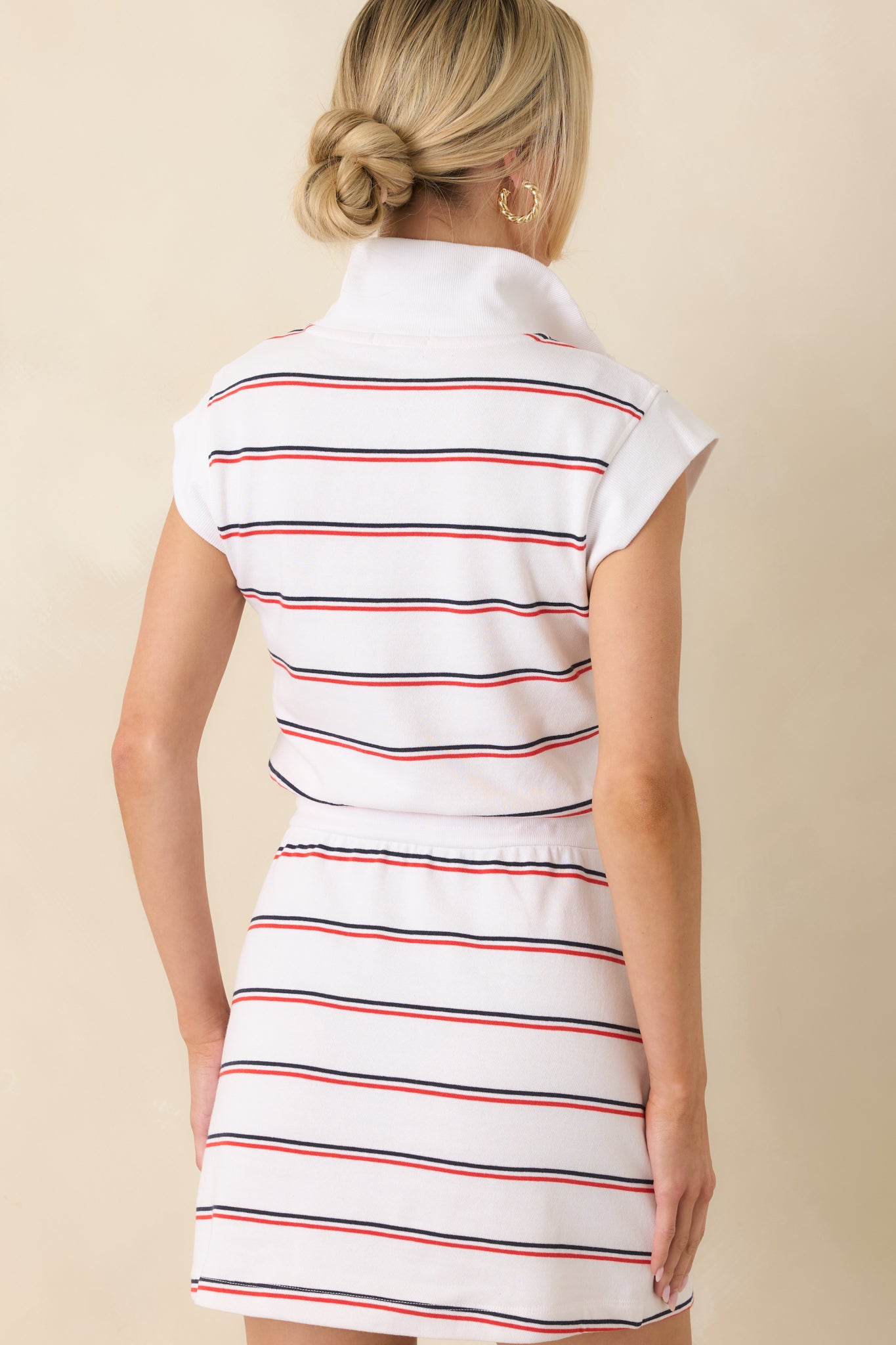Rear view of the mini dress featuring a clean sleeveless back, relaxed drape, and continuous easy-fit silhouette.