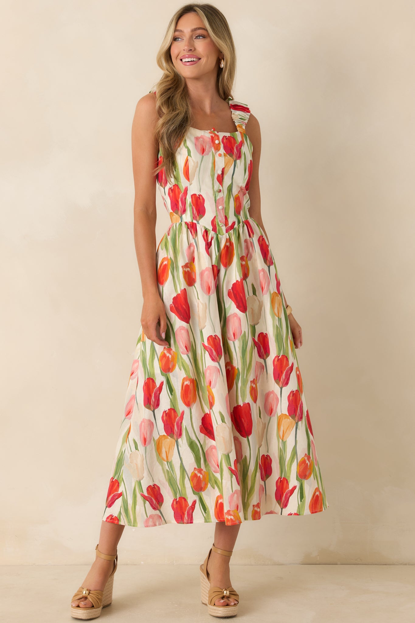 Ivory multi floral dress with vibrant tulip patterns, decorative front button detailing, and an airy midi-length shape.