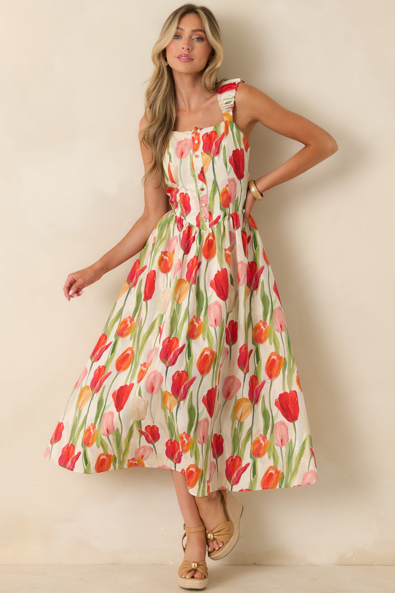 Ivory floral midi dress with a colorful tulip print, gathered elastic shoulder straps, and a flowy lined skirt.