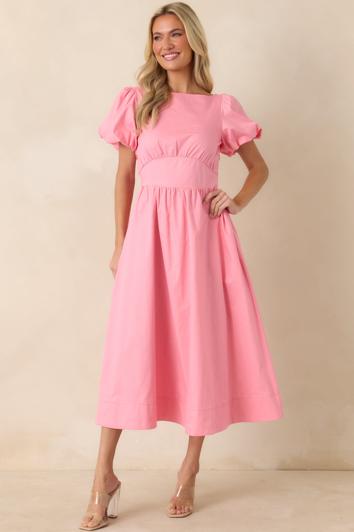 Cotton midi dress in pink showcasing a fitted bodice, puff sleeves, and a removable self-tie sash at the waist.