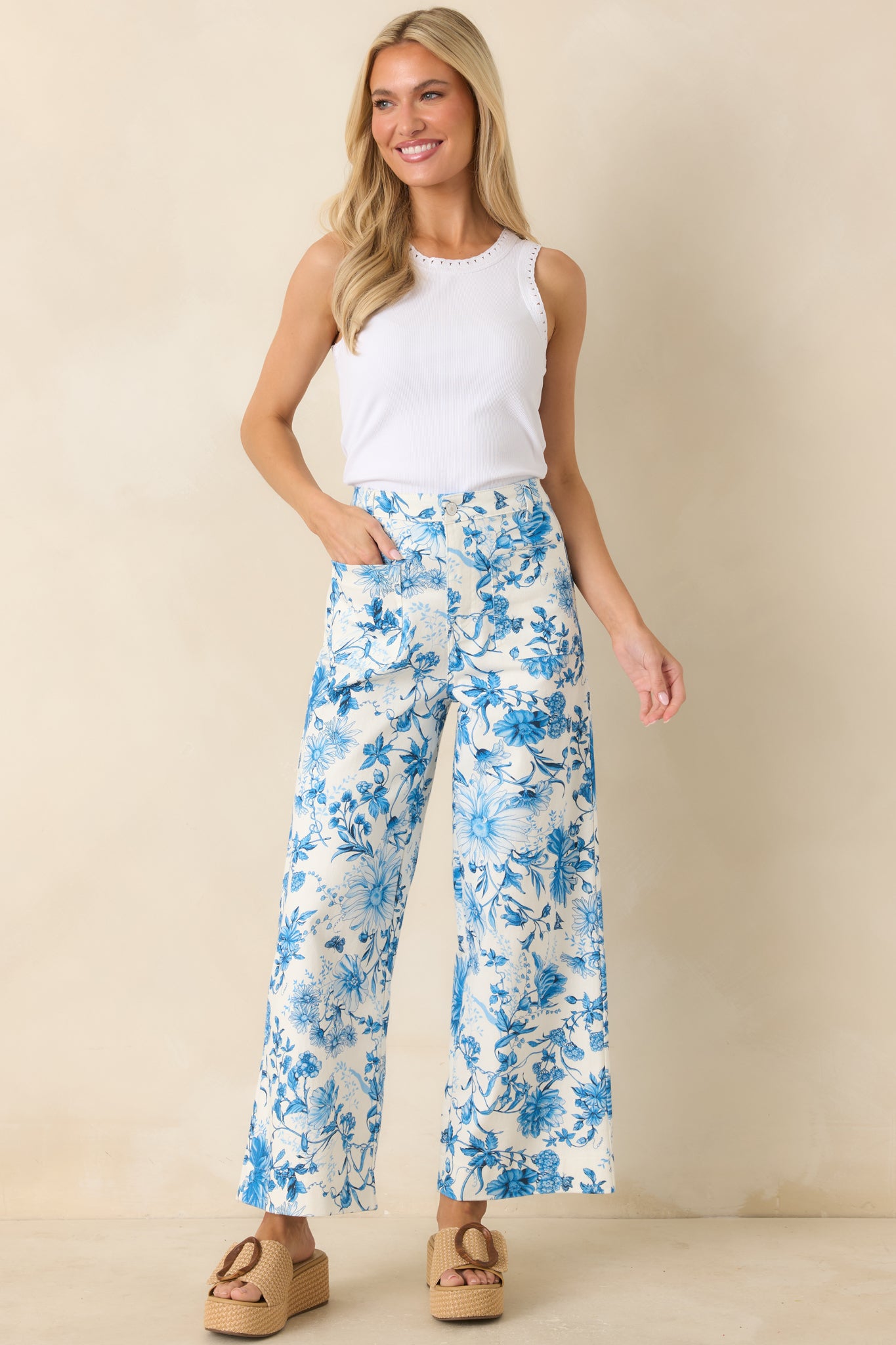 Breathable floral print pants featuring button front closure and garden-inspired pattern.