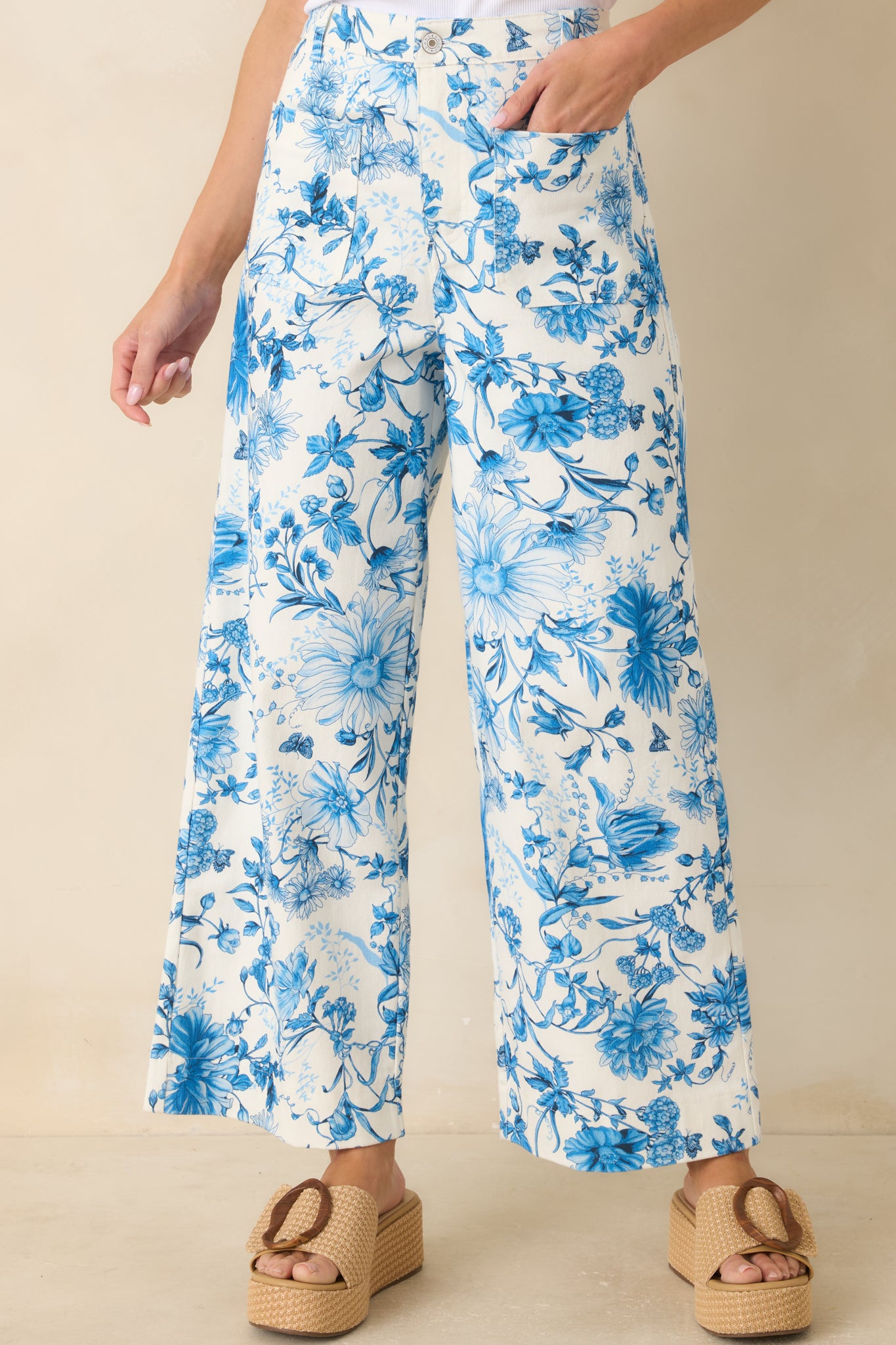 Detailed look at blue floral cotton fabric with stitching and waistband construction.